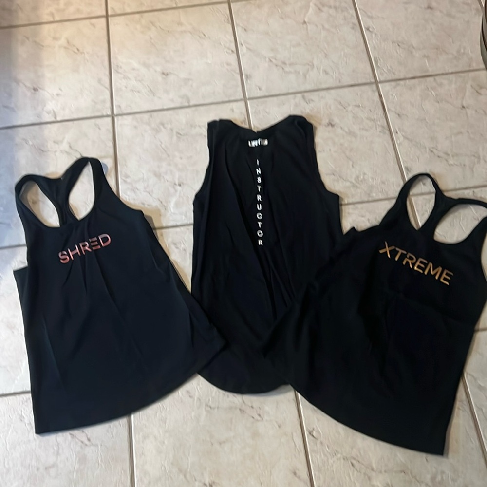 Set of three Lifetime Fitness instructor tank tops for shred, lift and XTREME